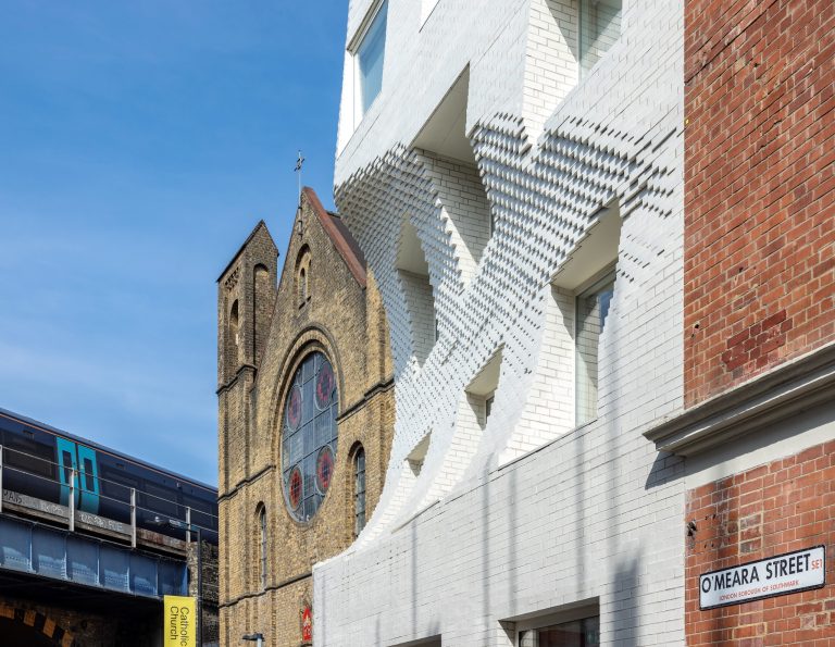 A view of The Scoop from the south end of O'meara Street. The Most Precious Blood church is visible next to The Scoop. The O'meara street placard is visible in the bottom right of the image.