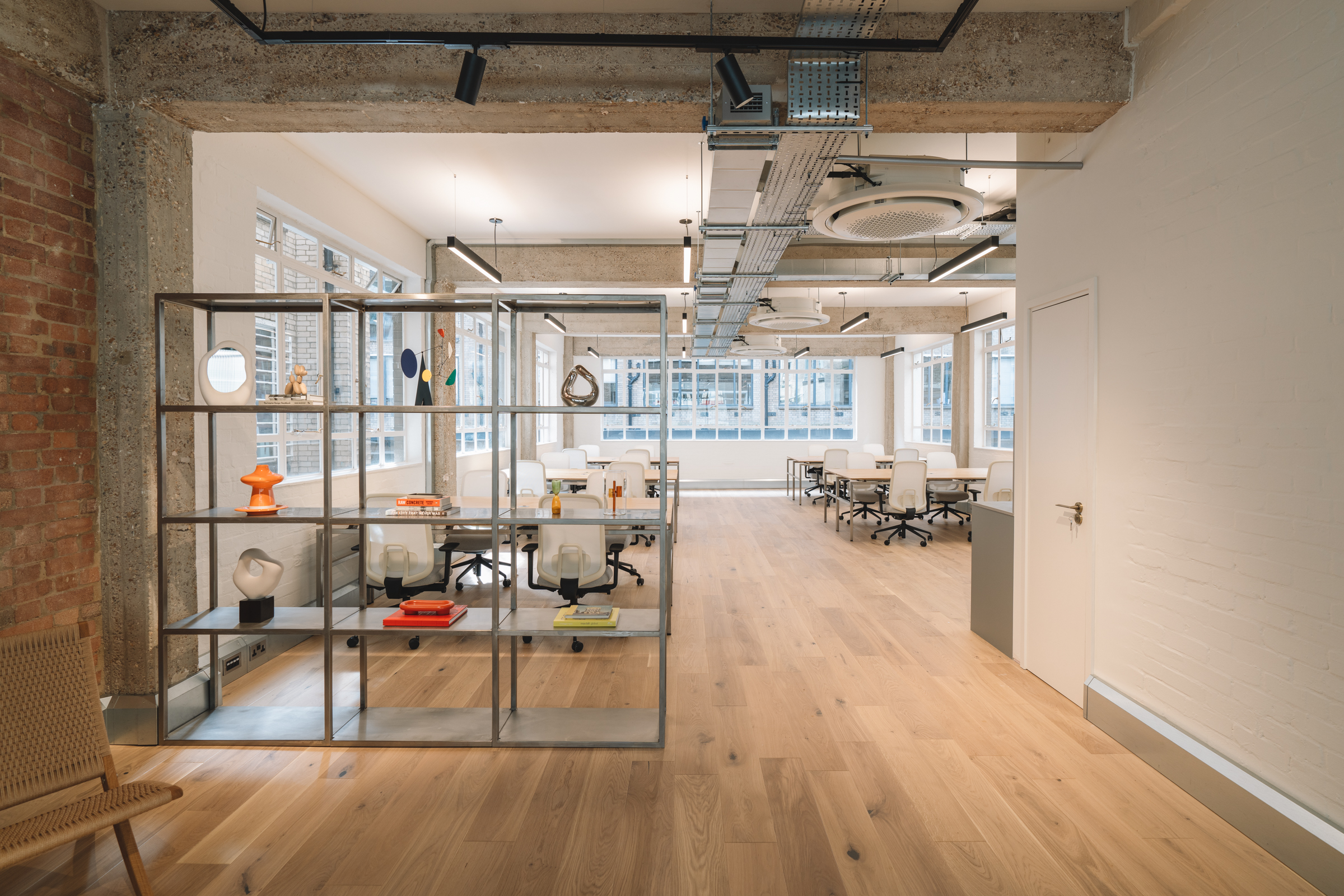 The stainless steel modular unit fabricated by Winthill Engineering acts as a room divider and essential storage for the staff at 11 - 12 Great Sutton Street