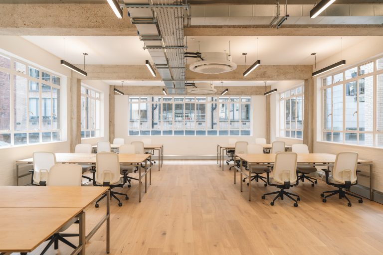 Large co-working tables are made from stainless steel topped with oiled birch ply