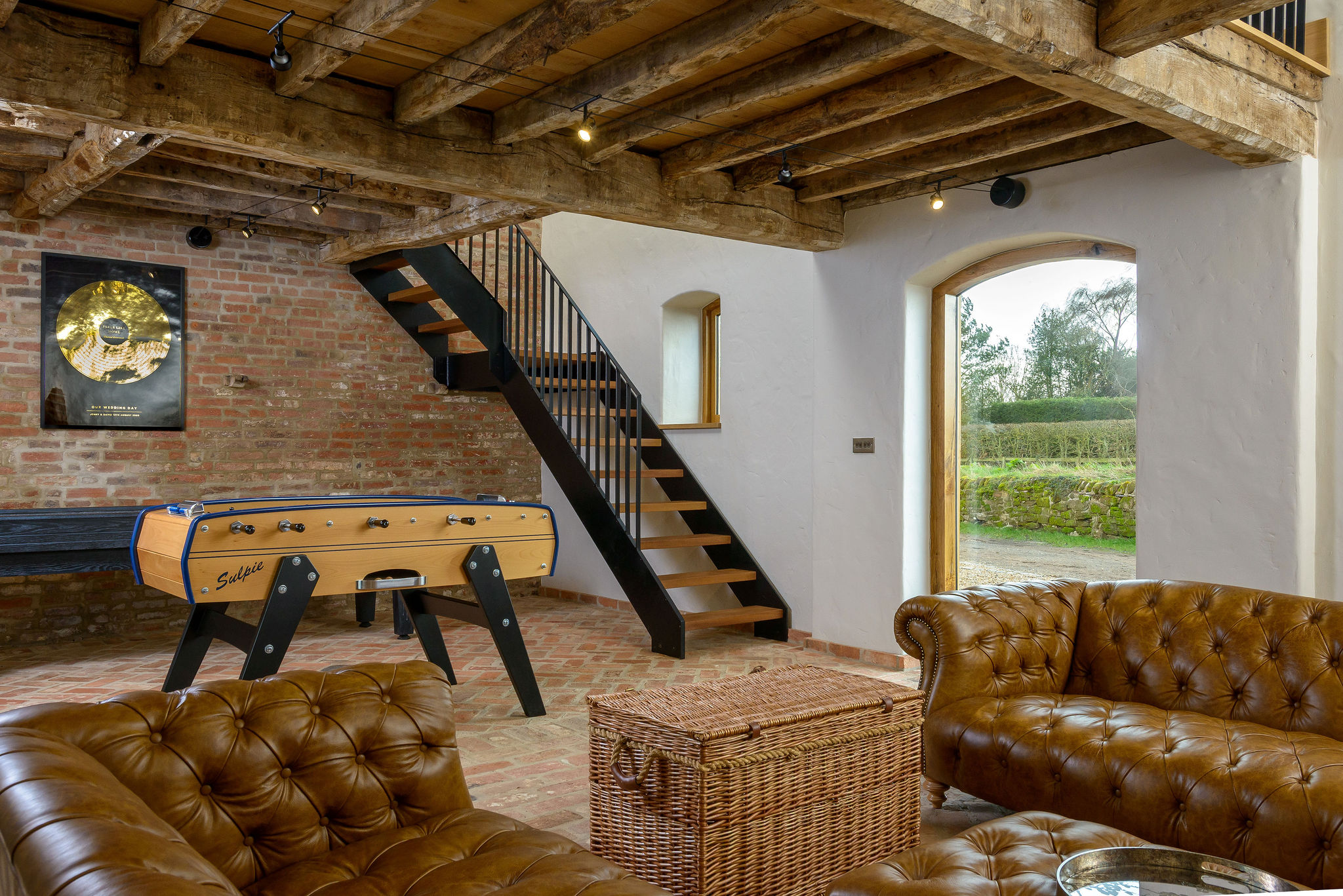 Bespoke steel and timber staircase installed along the exterior wall of an 18th-century Georgian barn conversion in Shropshire